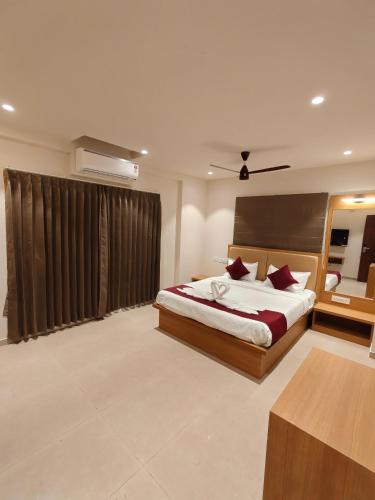a bedroom with a large bed in a room at Neelram Hospitality in Mangalore