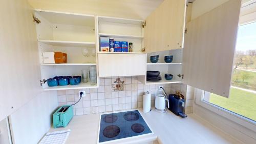 a small kitchen with a stove and a window at Practical Apartment Near Seebach in Zurich