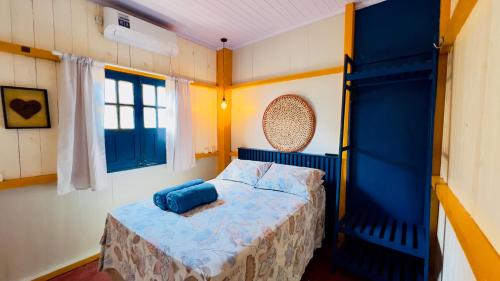 a bedroom with a bed and a blue bunk bed at Casa da Barra Tutóia in Tutóia