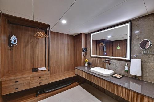 a bathroom with a sink and a mirror at Hotel Suba Star Ahmedabad in Ahmedabad