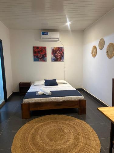a bedroom with a bed in a room with a rug at La Petite Maison in Antsiranana