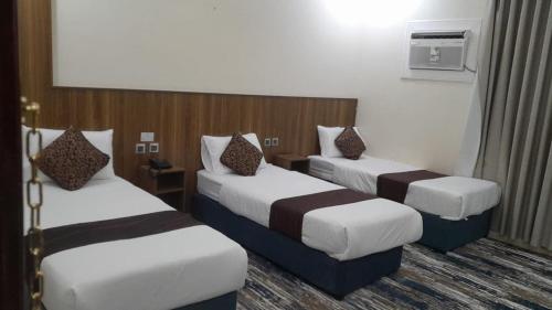 a hotel room with two beds and a television at بيت سلسبيل- salsbil house in Medina
