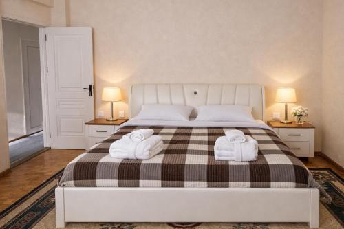 a bedroom with a bed with two towels on it at 5 minute from Airport Baku in Bina
