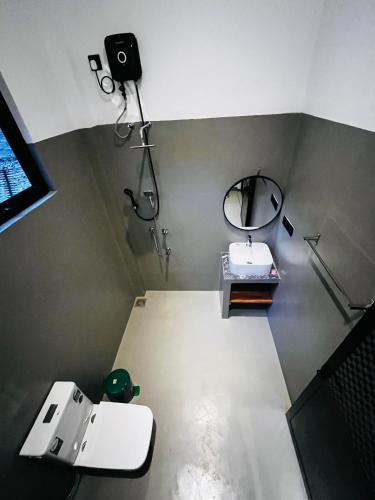 a bathroom with a sink and a mirror at Ancy Villa in Dickwella