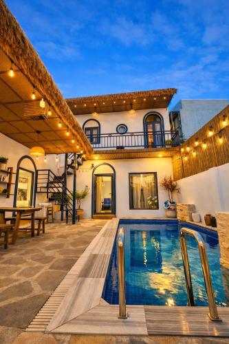 a house with a swimming pool in front of a house at Doc Bien Homestay Mui Ne - Entire Home in Ấp Khánh Phước (1)
