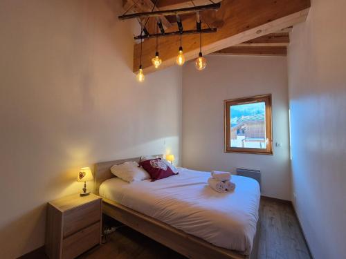 a bedroom with a bed with a teddy bear on it at Sublime appartement avec terrasse - Centre BSM in Bourg-Saint-Maurice