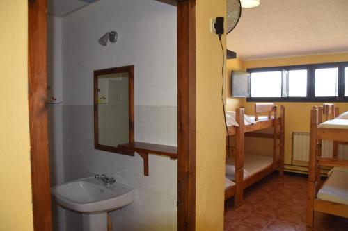 a bathroom with a sink and a mirror at Masia La Cadamont in Sant Joan les Fonts