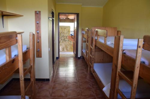 a room with a row of bunk beds at Masia La Cadamont in Sant Joan les Fonts