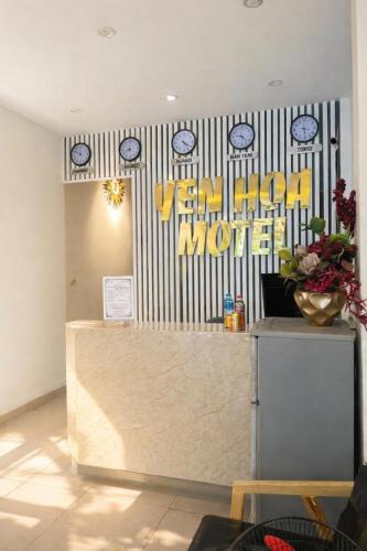 a restaurant with a counter with clocks on the wall at YÊN HÒA MOTEL in Hanoi