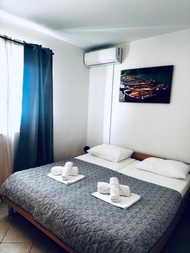 a bedroom with two beds with towels on them at Andreja in Kustići