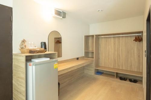 a kitchen with a refrigerator and a counter at The Krungkasem Srikrung Hotel in Bangkok