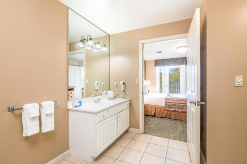 a bathroom with a sink and a mirror at Vacation Village in the Berkshires in Hancock