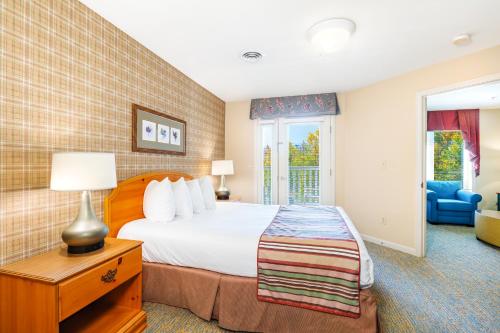 a hotel room with a bed and a window at Vacation Village in the Berkshires in Hancock