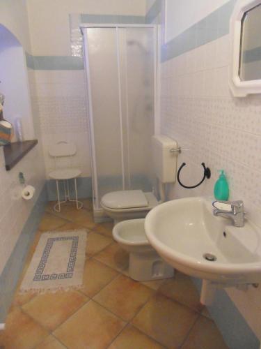 a bathroom with a toilet and a sink at B&B Cascina Marie in Bricherasio