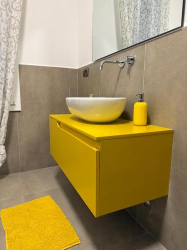 a bathroom with a bowl sink on a yellow counter at Villetta Brasi in Celle Ligure