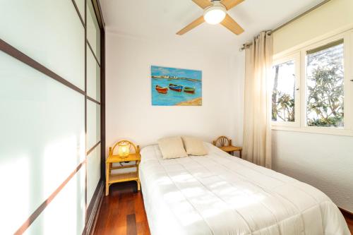 a bedroom with a bed and a ceiling fan at Atlantic View Apartment-El Rompido in El Rompido