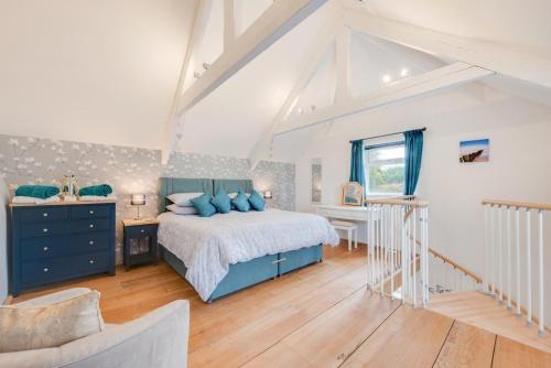 a bedroom with a blue bed and a desk at 1 Bed in West Putford oc-thymw in Bulkworthy