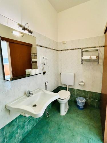 a bathroom with a sink and a toilet at Smart Rooms in Molinella