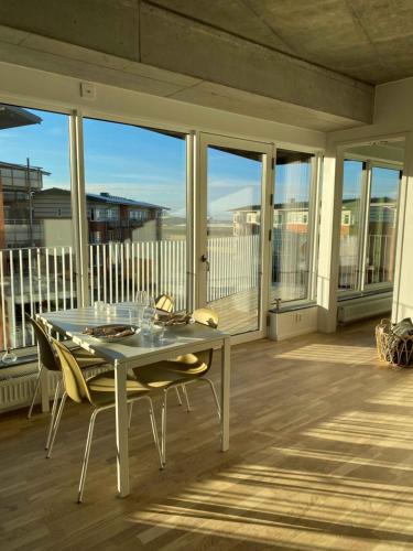 a table and chairs on a porch with a view of the ocean at Place Lund Apartments in Lund