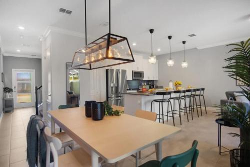 a kitchen and dining room with a table and chairs at Stunning 4BR at ChampionsGate - Pool & BBQ in Kissimmee