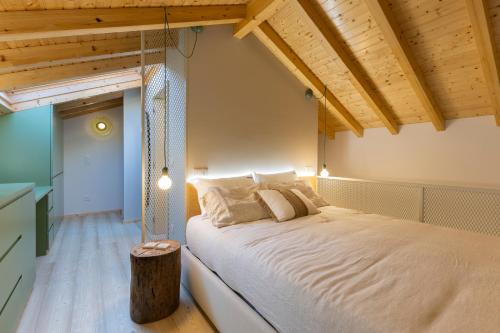 a bedroom with a bed in a room with wooden ceilings at Lobo do Mar in Viana do Castelo