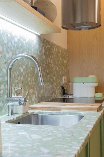 a kitchen with a sink and a counter top at Lobo do Mar in Viana do Castelo