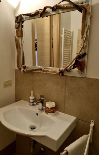 a bathroom with a white sink and a mirror at B & B Stella Marina in Taranto