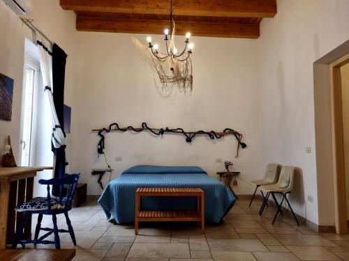 a bedroom with a bed and a chandelier at B & B Stella Marina in Taranto