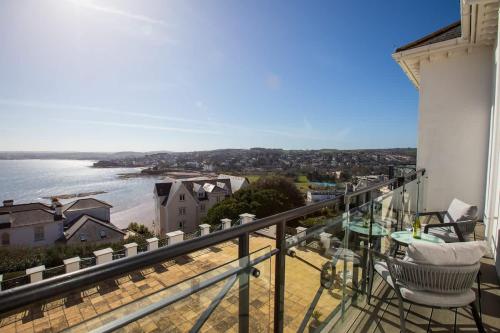 a balcony with chairs and a view of the water at Breathtaking Views at The Bay in Torquay