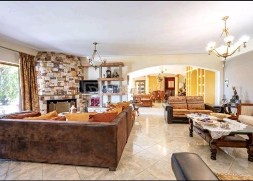 a large living room with couches and a fireplace at Stone Horizon Villa in Eretria