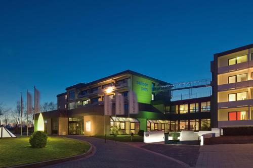 a large building with lights on at night at Ferienwohnung Salinenparc Design Budget Hotel in Erwitte