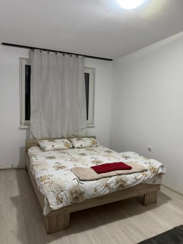 a bedroom with a large bed in a white room at Turda central apartament in Turda