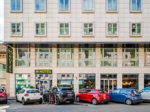 a large building with cars parked in front of it at B&B Hotel Milano Central Station in Milan