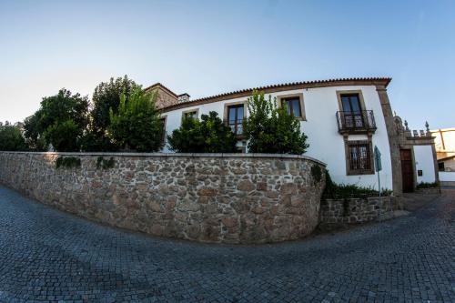 a stone retaining wall in front of a house at Turismo Homes Solar Do Areal in Braga