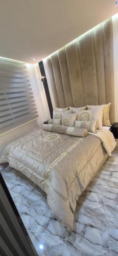 a bedroom with a large bed with a marble floor at Casa españa LUXURY in Tangier