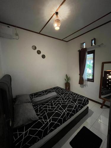 a bedroom with a bed and a ceiling fan at In Home stay in Bulakbenda