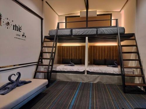 two bunk beds in a room with a ladder at Pool&chill kohlarn in Ko Larn