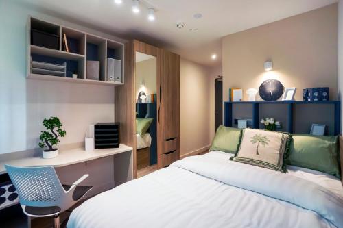 a bedroom with a bed and a desk and a chair at The Artisan - City Centre in Dublin