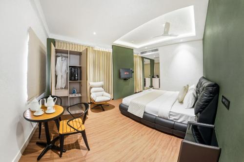 ein Hotelzimmer mit einem Bett und einem Tisch in der Unterkunft Hotel A Square Rivera in Salem
