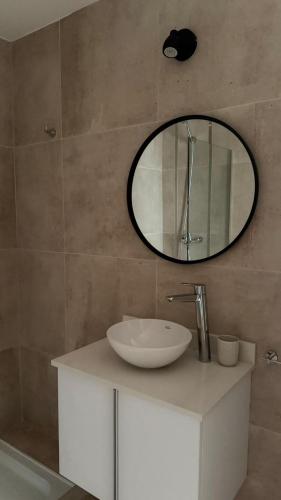 a bathroom with a sink and a mirror on the wall at Garden Inn II 5 in Santa Fe