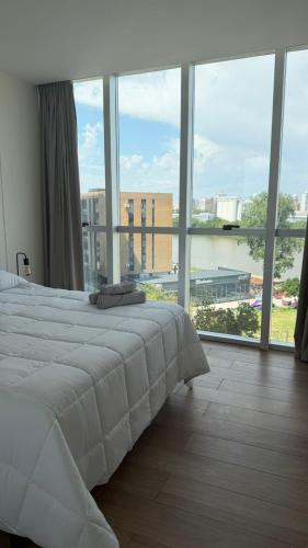 a bedroom with a white bed and a large window at Garden Inn II 5 in Santa Fe