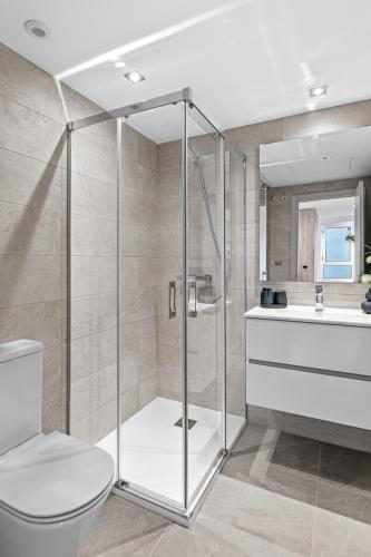 a bathroom with a shower and a toilet and a sink at Solana Village in Málaga