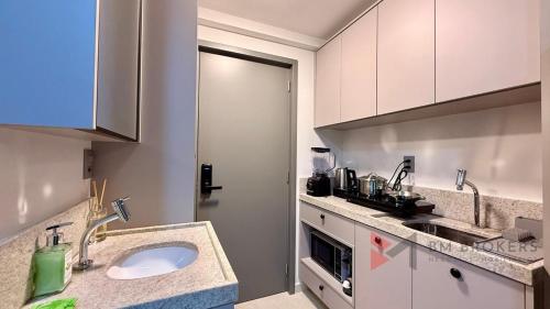 a kitchen with a sink and a counter top at Flat Beira Mar 331 - 424 - 426 in João Pessoa