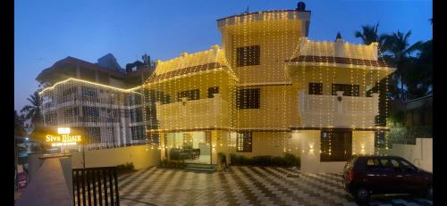 a large yellow building with lights on it at Siva Bharg Residency in Kovalam