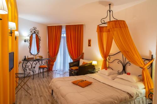a bedroom with a large bed with orange curtains at Familly Art Hotel Nirvana in Shumen