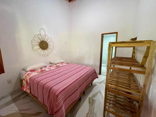 a small bedroom with a bed and a mirror at Recanto do Matuto in Amargosa