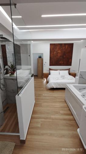 a large room with two beds and a bathroom at Lūma Retreat in Kastoria