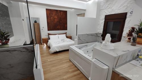 a white bathroom with a tub and a bed at Lūma Retreat in Kastoria