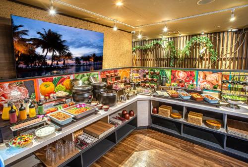 a buffet line with food on display in a restaurant at Hotel Pasela Living Shinjuku in Tokyo