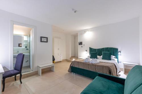 a bedroom with a large bed with green pillows at Il Tesoro Smart Suite & SPA in Naples